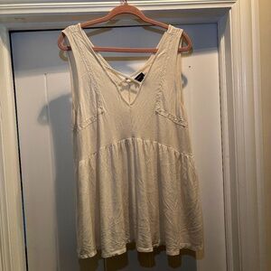 white babydoll-style sleeveless top